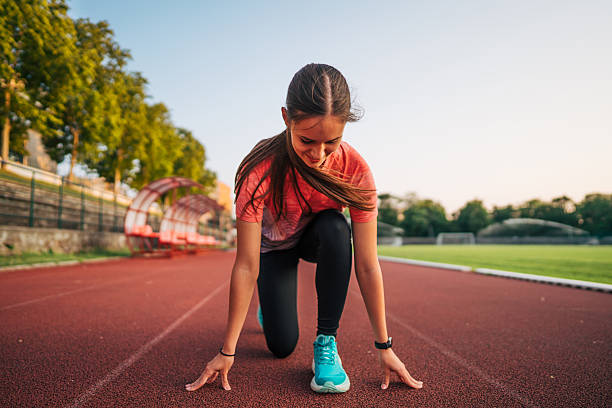 istock Young female athlete preparing for a run on a track 2219819284