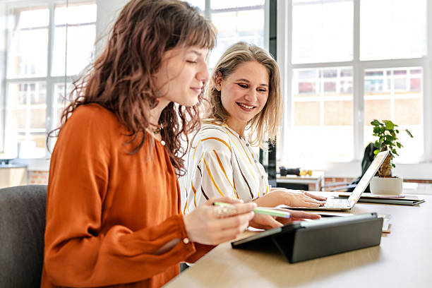 istock Dynamic collaboration among young businesswomen in a modern office setting with technology at hand 2219821839