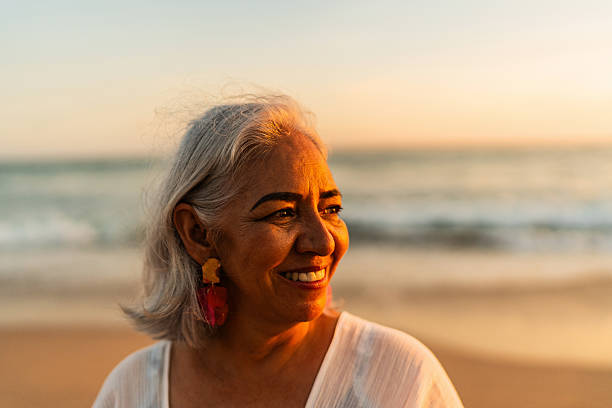 istock Senior woman admiring the view on the beach 2219821995