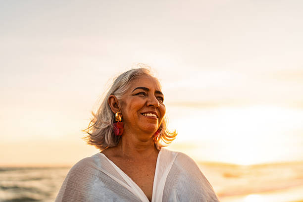 istock Senior woman admiring the view on the beach 2219822029