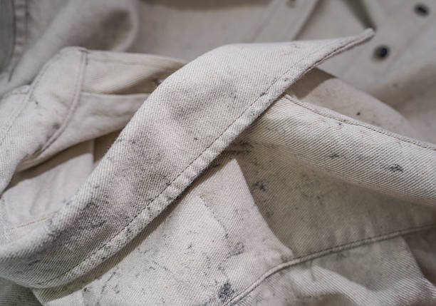 istock Close-Up of Light Beige Textile Shirt with Speckled Pattern and Button Details 2219822293