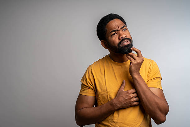 istock Pensive afro american man looking up at copy space 2219822537