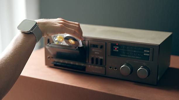 istock A woman's hand with a smartwatch inserts a cassette into a tape recorder. 2219823777