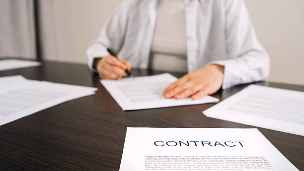 istock Signing a contract at a home office with paperwork and documents on the table 2219825431