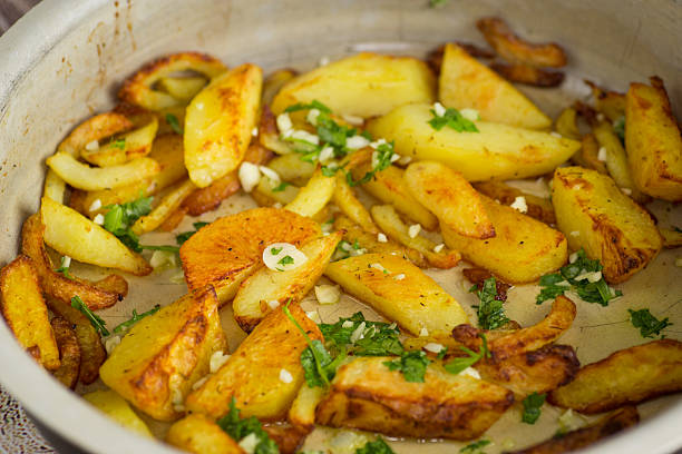 Appetizing baked potatoes with garlic and herbs.