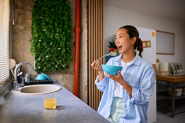 istock Young woman enjoying a healthy breakfast in her modern kitchen 2219826910