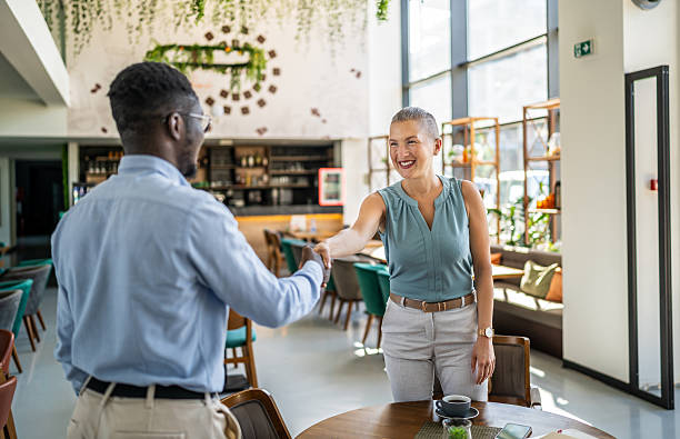 istock Business people shaking hands in modern cafe 2219826961