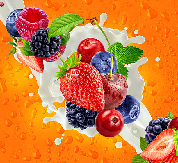 istock Assorted berries, milk splash, vibrant orange background. 2219827346
