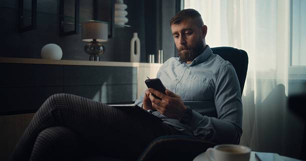istock Focused Stock Exchange Trader Using Smartphone, Analyzing Real-Time Stocks 2219827423