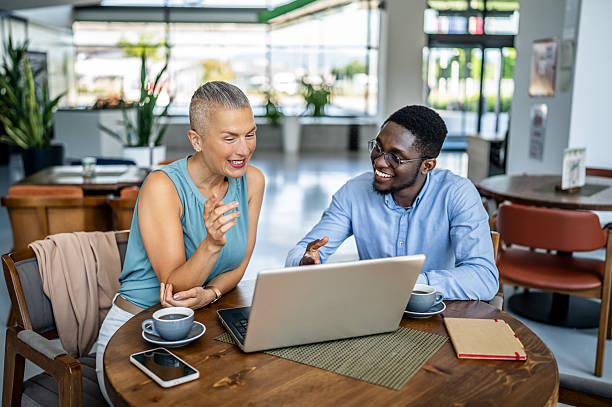 istock Business people having a meeting at a cafe, using laptop 2219828042
