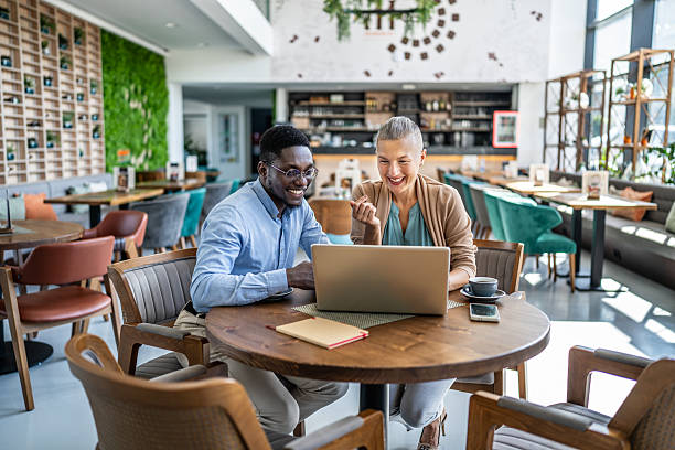 istock Business people working on laptop in a cafe 2219828065