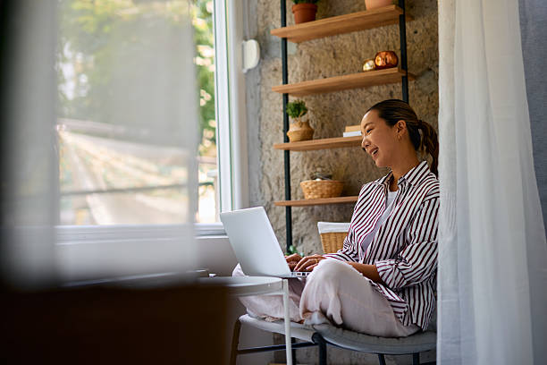 istock Young Woman Working From Home on Laptop and Smiling 2219828740