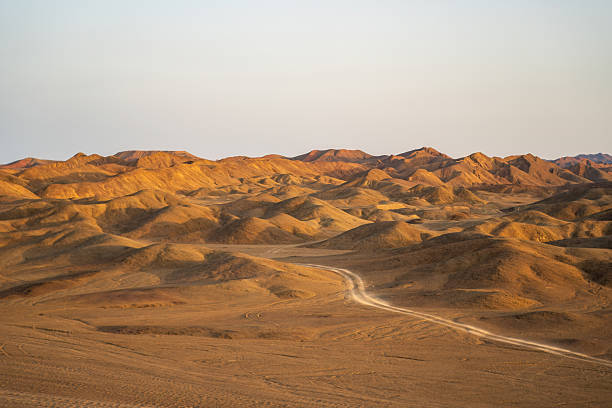 istock A serene view of rolling desert hills illuminated by warm sunlight 2219831420