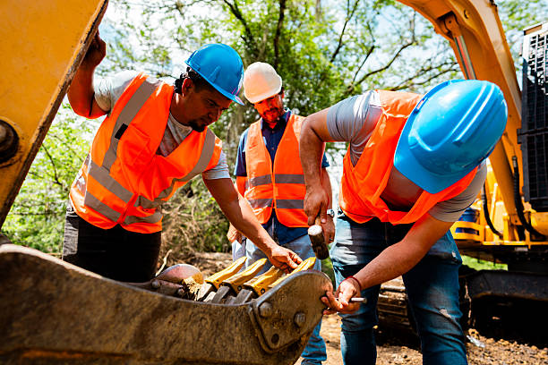 istock Construction workers inspecting excavator bucket at site outdoors 2219832569