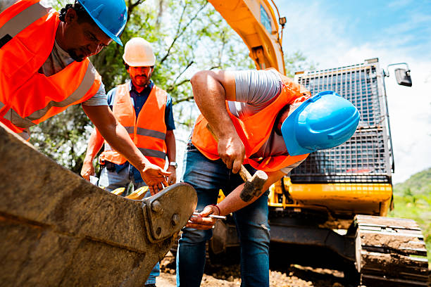 istock Construction workers inspecting excavator bucket at site outdoors 2219832584