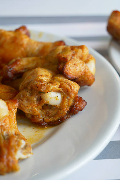Delicious spicy chicken wings are plated for diners to enjoy.