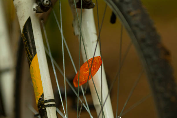 Close-up of bicycle wheel in neon lighting
