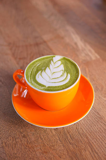 istock Beautiful matcha latte with intricate leaf design in vibrant cup 2219835630