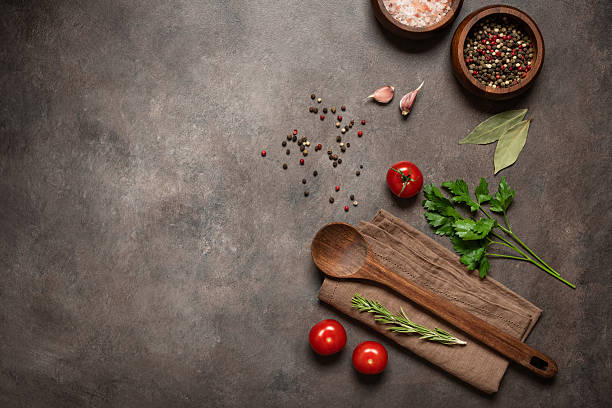istock Wooden spoon with various cooking ingredients on dark rustic background flat lay 2219836797