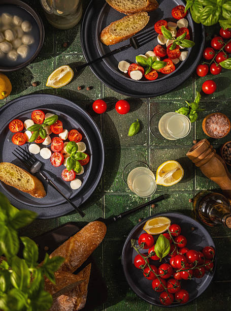 Fresh mediterranean meal with caprese salad and baguettes