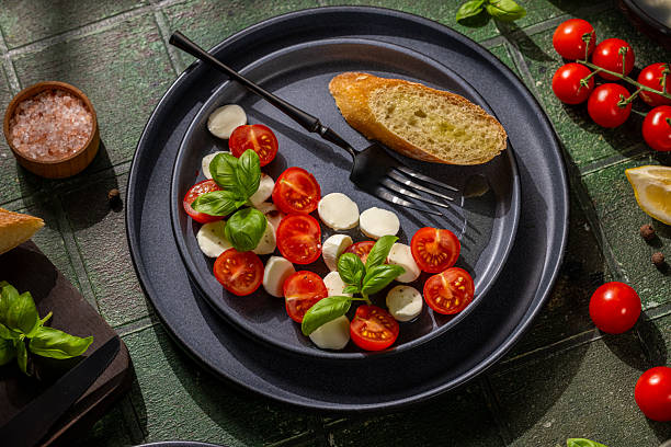istock Fresh caprese salad with cherry tomatoes and basil 2219837622