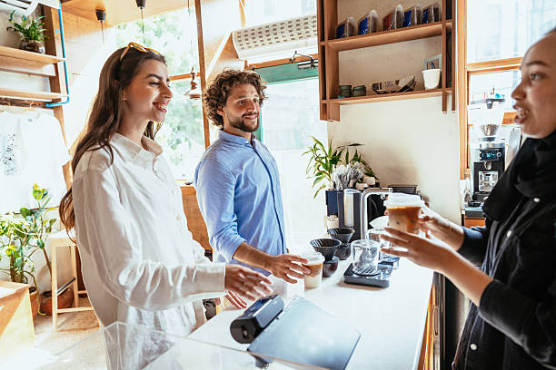 istock Female barista working in modern cafe, preparing coffee and serving customers 2219841727