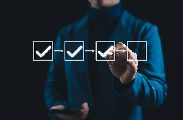 istock Checklist Process and Quality Assurance Workflow Concept. Businessperson checks checkboxes, symbolizing task management, step-by-step processes, workflow control, quality assurance, and productivity. 2219844163