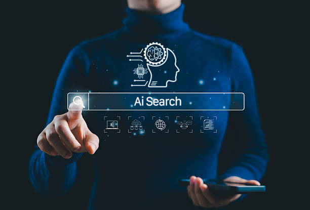 istock AI Search Interface and Smart Technology Concept. A person interacts with AI search bar and digital icon, machine learning, data networks, and global connectivity, symbolizing smart search technology. 2219844164