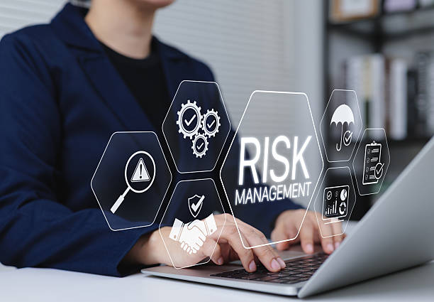 istock Risk Management and Assessment Strategy Concept. A professional using laptop with icon labeled RISK MANAGEMENT, representing business risk analysis, prevention, and strategic assessment in operations. 2219844172