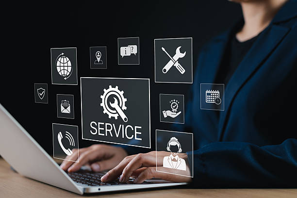 istock Technical Support and Customer Service Concept. A Professional uses laptop with SERVICE icons, featuring tools, headset, email, and calendar representing customer support and technical assistance. 2219844173