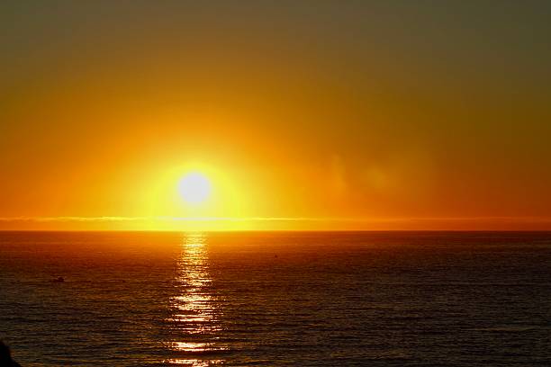 Golden sunset reflecting over a tranquil lake or sea
