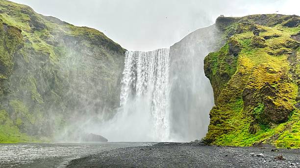 istock Waterfall cascading down with a dramatic cliff rising behind it in Rangaring eystra, Iceland 2219845413