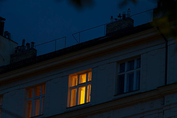 istock The Illuminated Apartment Window Shining Brightly at Nighttime Hours 2219846291