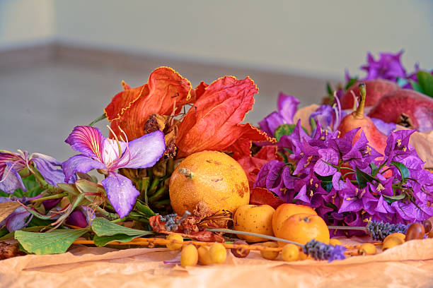 Beautiful still life with fruit, seeds, flowers and leaves on the light table