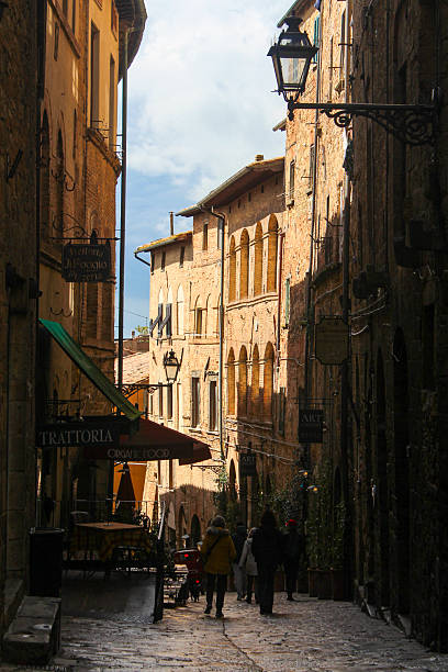 Volterra, Italy - March 2025:  Street in the old town of Volterra, a mountaintop town which has been continuously inhabited since the end of the 8th century BC.\nVolterra was conquered by the Republic of Florence, after it's reign fell it was controlled by the Medici family.