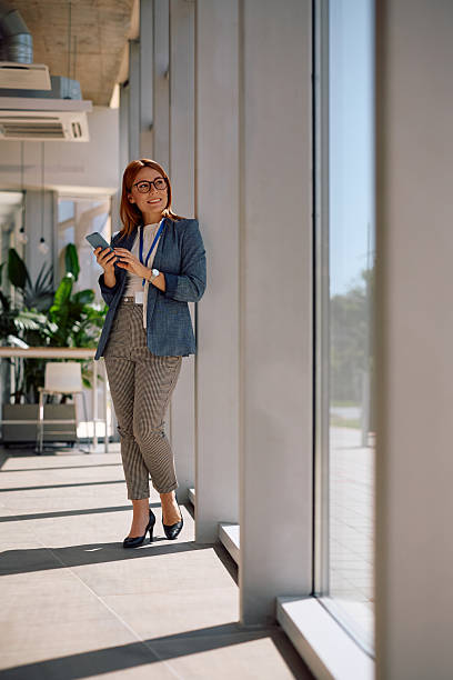 istock Happy businesswoman using smart phone while working in the office. 2219850870