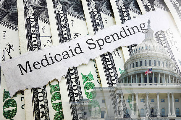 istock Medicaid newspaper headline on hundred dollar bills with US Capitol 2219853991