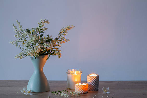 istock white lilac flowers in vase with burning scened candles 2219854567