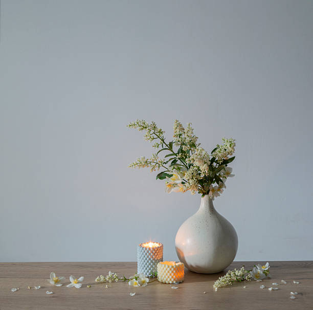 istock white lilac flowers in vase with burning scened candles 2219854568