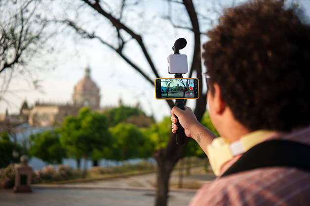 istock Content creator filming an urban landscape with a smartphone gimbal 2219856199