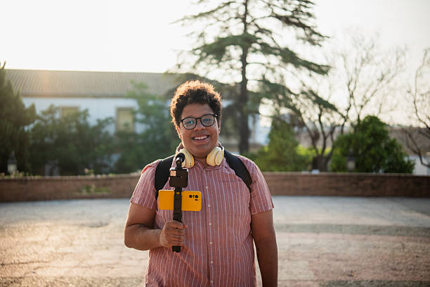 istock Young man vlogging outdoors with a smartphone gimbal and microphone 2219856203