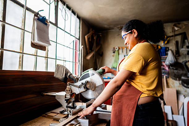 istock Young pregnant woman using circular saw in carpentry workshop 2219857155