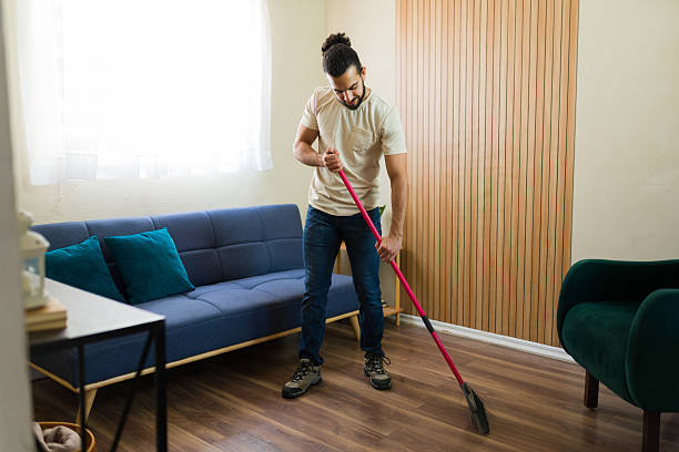 istock Hispanic man sweeping the floor in modern living room 2219861177