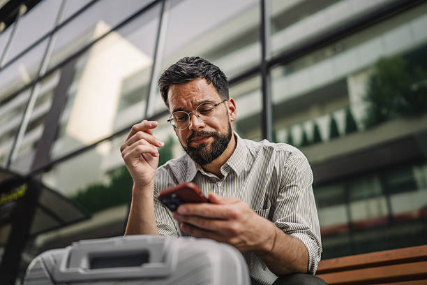 istock Worried businessman have a headache and use cellphone on bench 2219861481