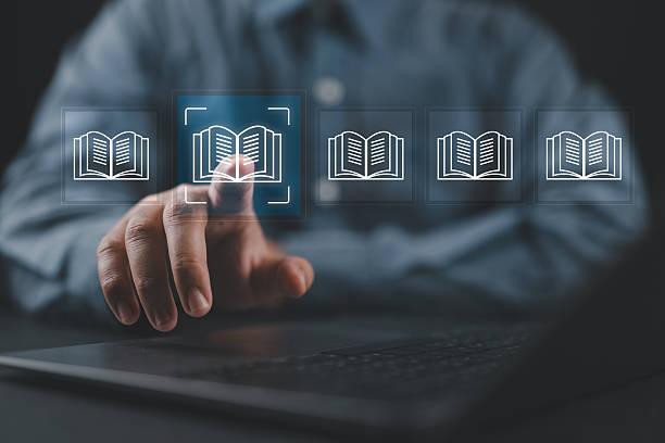 istock E-library concept. Person use smartphone and hand touch with virtual Ebook icons for electronic books online, knowledge base on internet, digital library or e-library. 2219862578