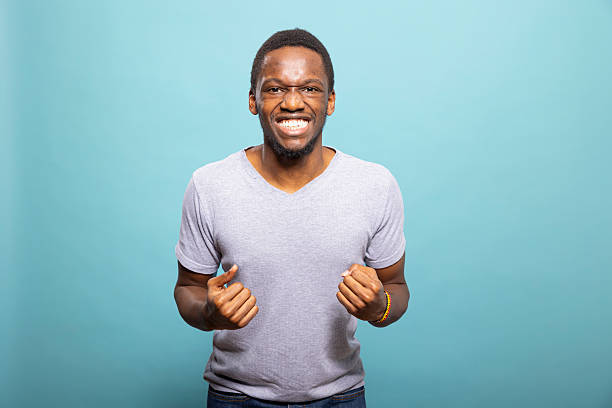 istock Excited man cheering with fists raised 2219863446
