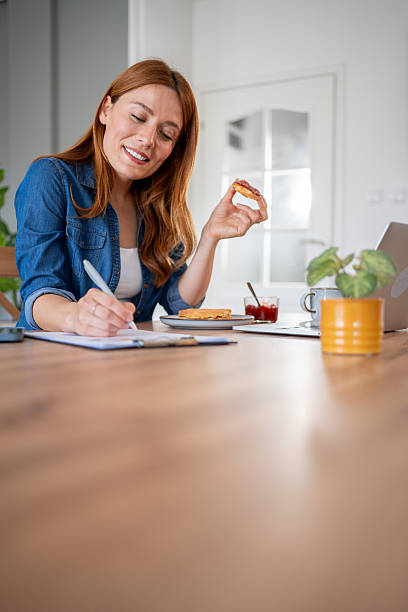 istock Freelancer woman working from home and having breakfast 2219864288