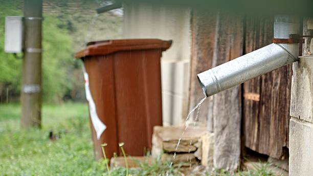 istock Spring Rainy Season. Water Flowing From Gutter Pipe 2219866042