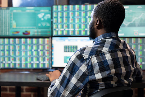 istock Young trader monitoring forex charts 2219870058