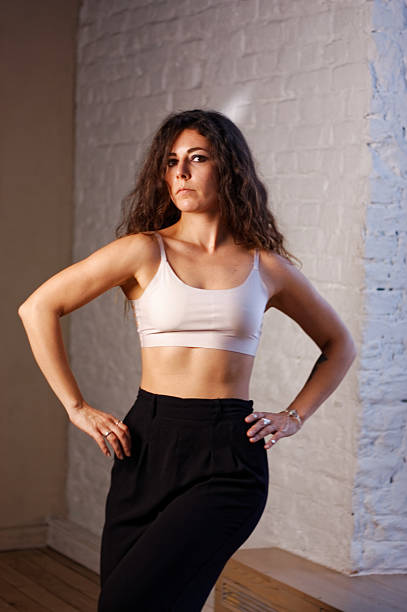 istock A young woman in white bra and black pants 2219872963